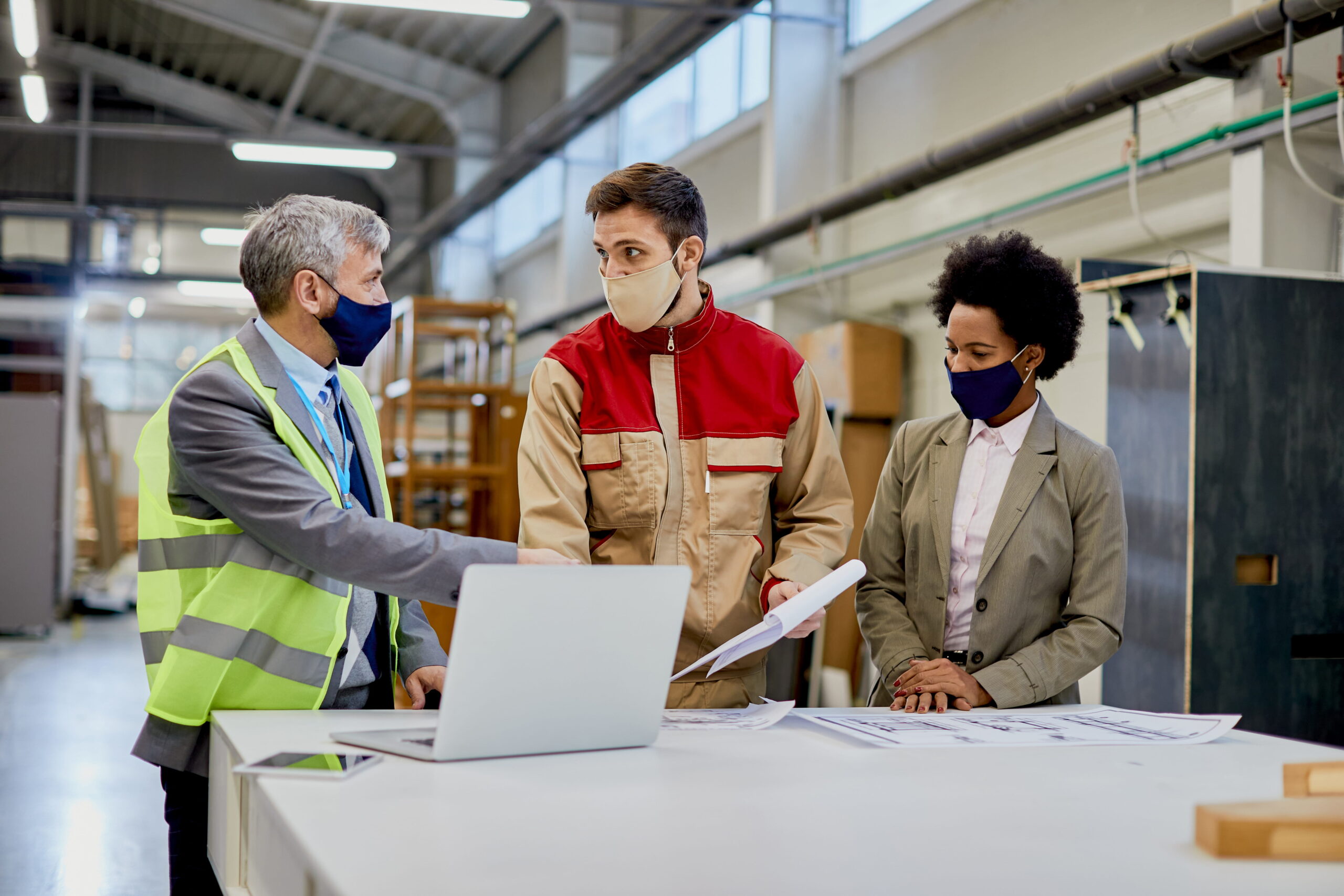 woodworking-company-managers-communicating-with-male-worker-production-facility-1-scaled.jpg